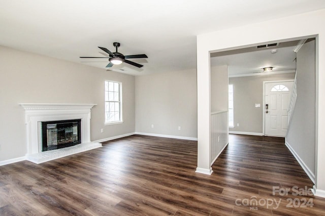 unfurnished living room with dark hardwood / wood-style floors, ceiling fan, and crown molding