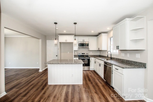 kitchen with white cabinets, sink, dark hardwood / wood-style floors, a kitchen island, and stainless steel appliances