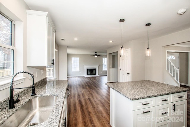 kitchen featuring white cabinets, a healthy amount of sunlight, and sink