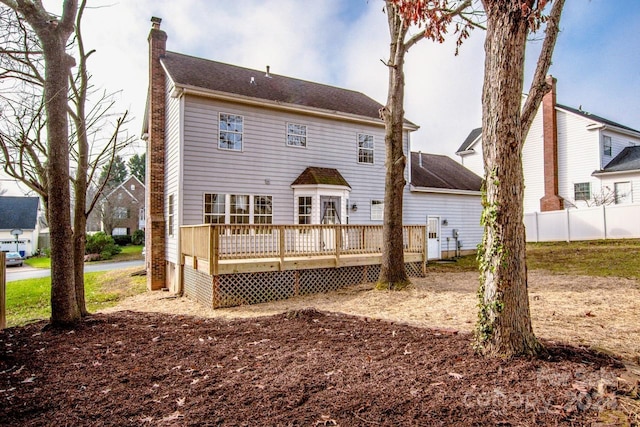 back of house featuring a wooden deck