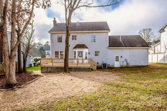 back of house featuring central air condition unit, a lawn, and a wooden deck