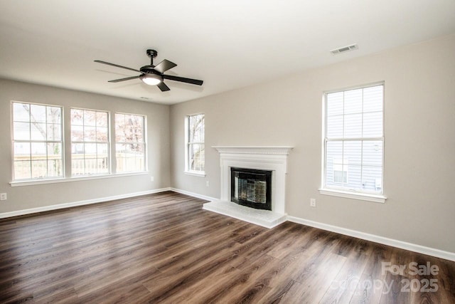 unfurnished living room with ceiling fan and dark hardwood / wood-style flooring