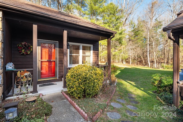 entrance to property with a yard and a porch