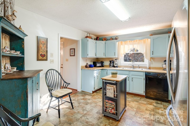 kitchen with black appliances, sink, blue cabinetry, and a textured ceiling