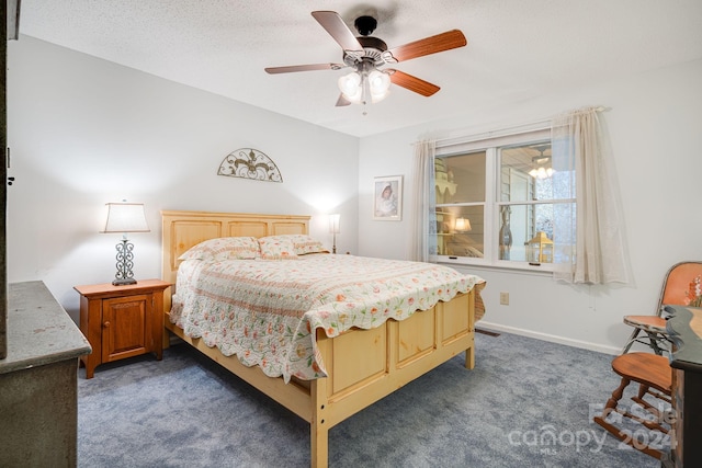 carpeted bedroom with ceiling fan and a textured ceiling