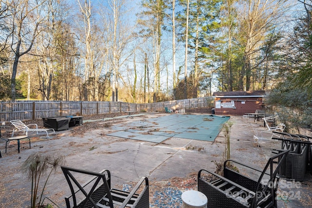 view of patio / terrace featuring a covered pool