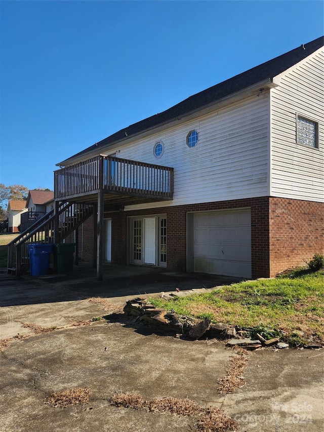 exterior space featuring a wooden deck and a garage