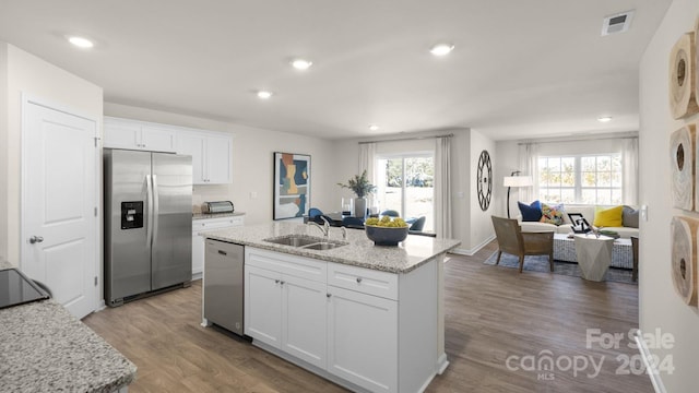 kitchen featuring hardwood / wood-style floors, stainless steel appliances, white cabinetry, and sink