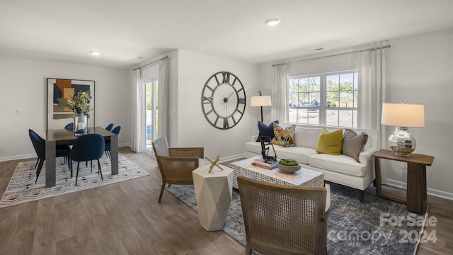 living room featuring dark hardwood / wood-style flooring and a healthy amount of sunlight