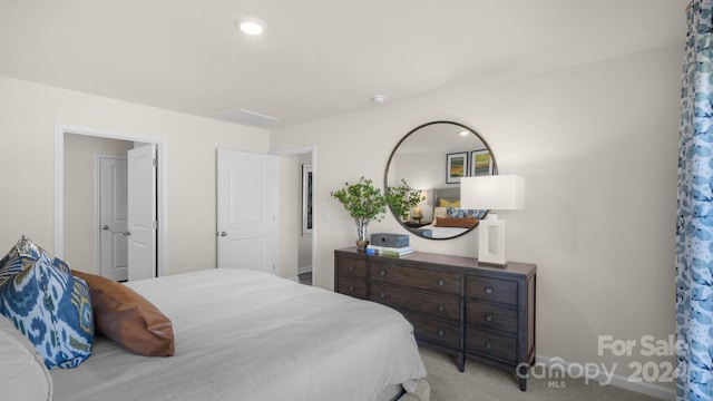 bedroom featuring light carpet