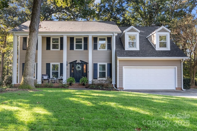 view of front facade with a garage and a front lawn