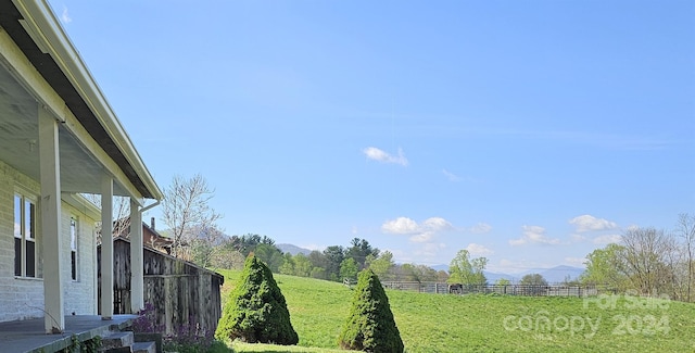 view of yard featuring a mountain view and a rural view