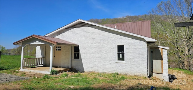 view of side of property with covered porch