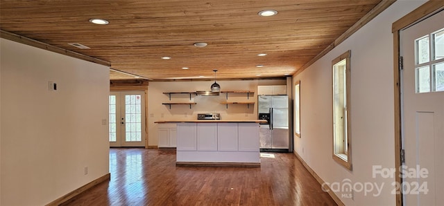 kitchen featuring white cabinetry, stainless steel refrigerator with ice dispenser, hanging light fixtures, and wooden ceiling