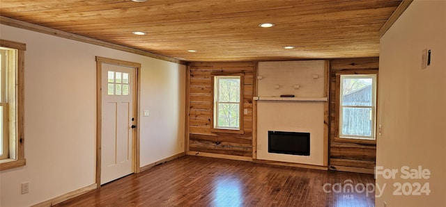 foyer entrance with dark hardwood / wood-style floors, wood walls, and wooden ceiling