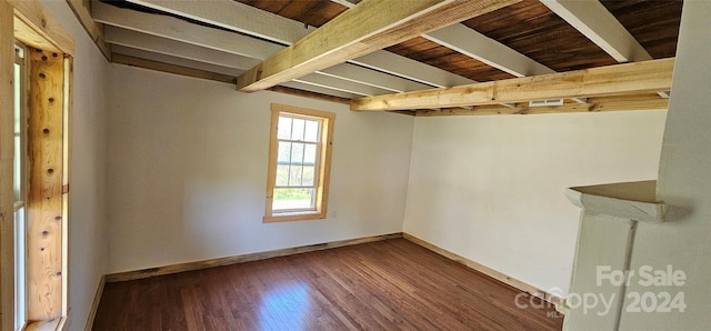 basement featuring dark hardwood / wood-style floors and wood ceiling