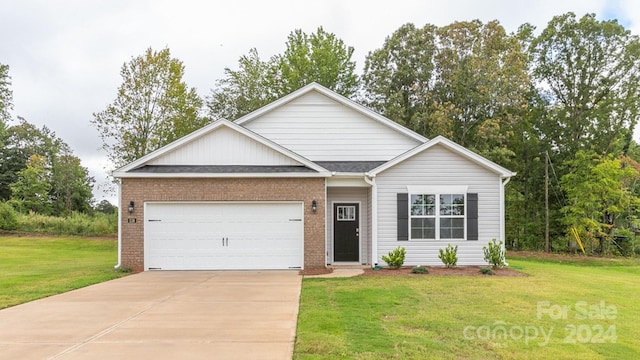 view of front of house with a front lawn and a garage