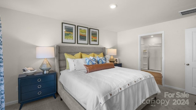 carpeted bedroom featuring a walk in closet and a closet