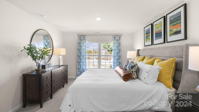 bedroom featuring light carpet