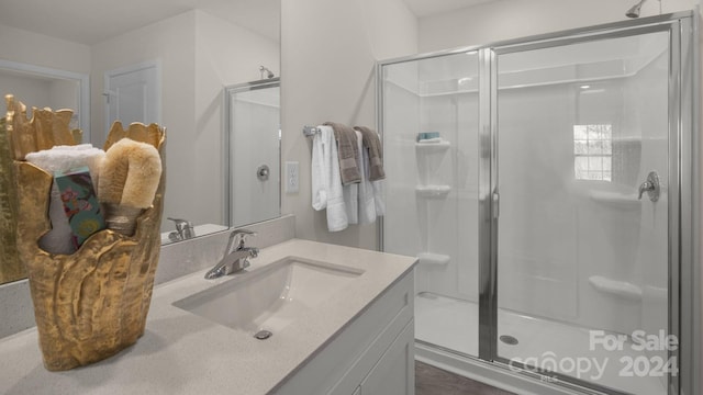 bathroom featuring vanity and an enclosed shower