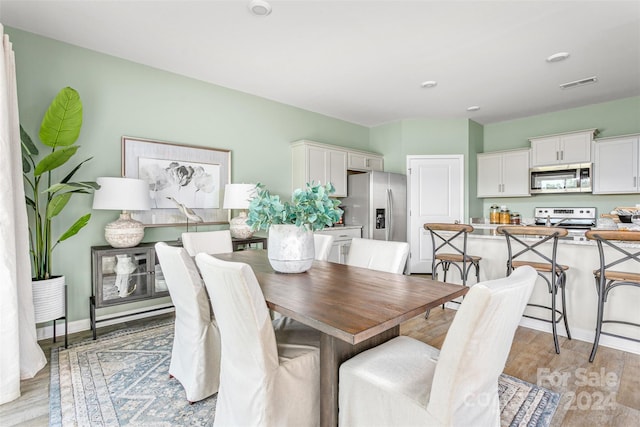 dining space with light hardwood / wood-style floors