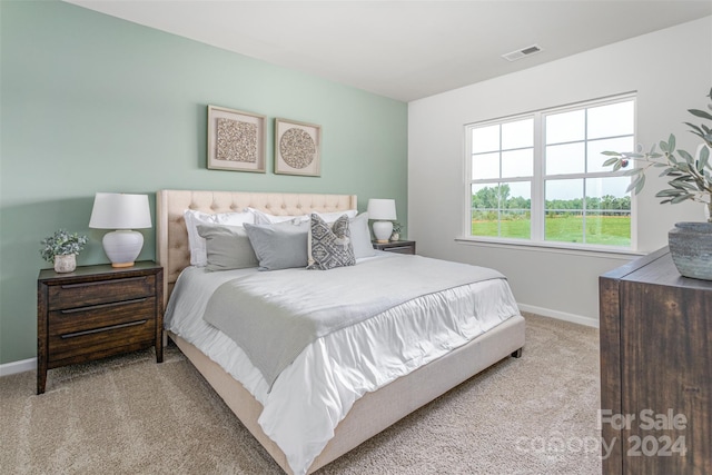 bedroom featuring light carpet