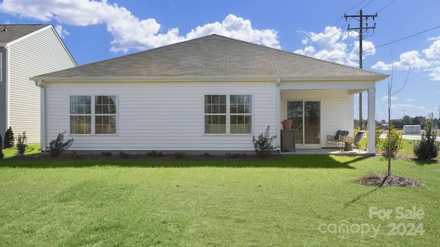 back of house with a yard