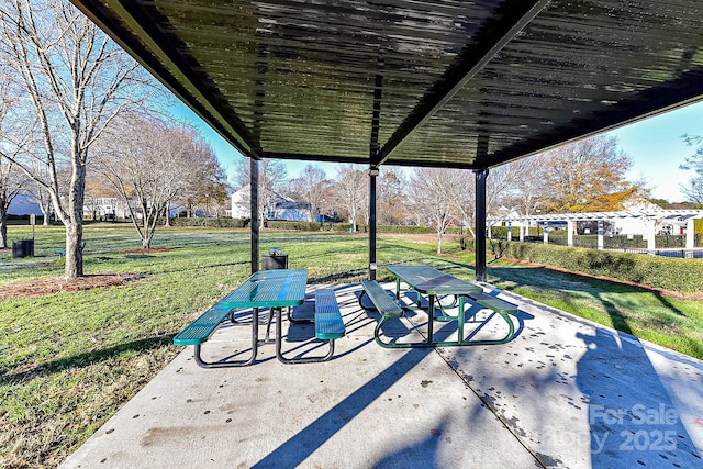 view of community featuring a pergola, a patio area, and a lawn