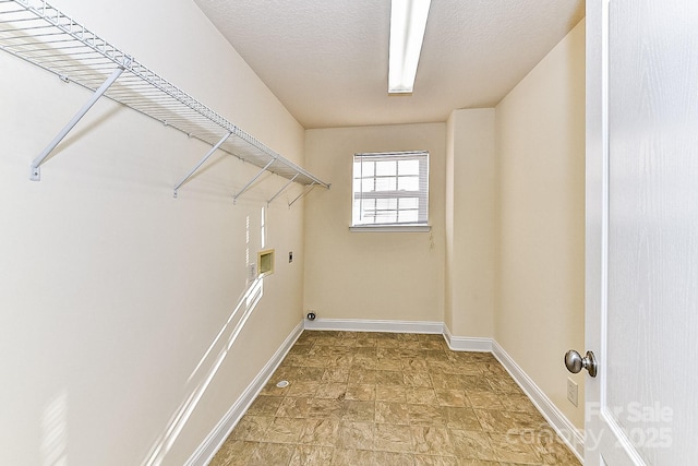 washroom featuring washer hookup, a textured ceiling, and electric dryer hookup