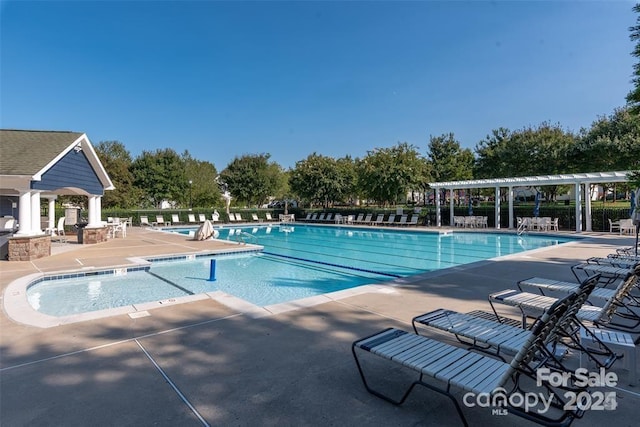 view of swimming pool with a pergola and a patio