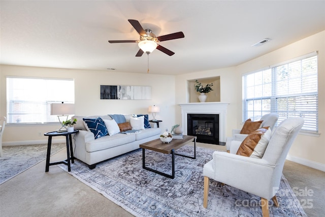 living room with a healthy amount of sunlight, light colored carpet, and ceiling fan