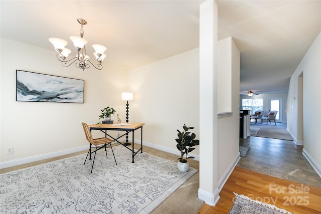 office featuring ceiling fan with notable chandelier