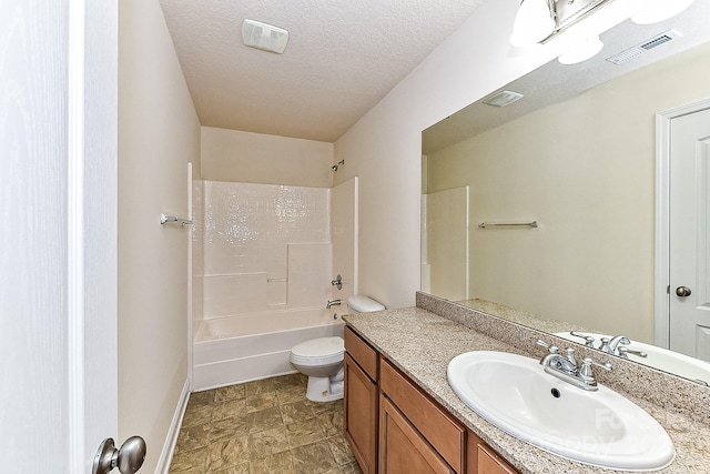 full bathroom with vanity, a textured ceiling, toilet, and washtub / shower combination