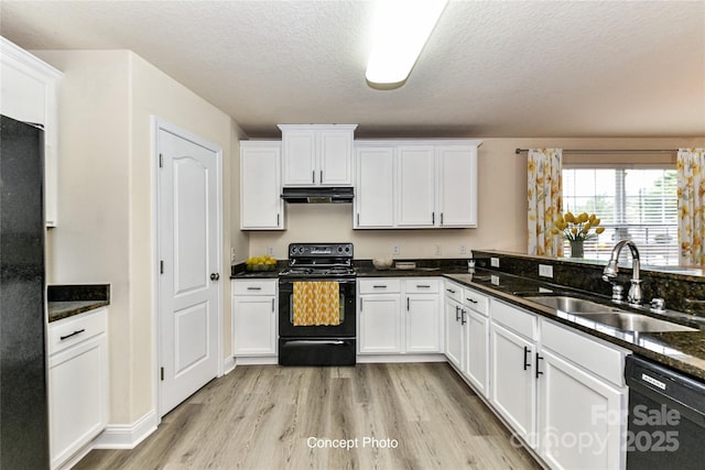 kitchen with a sink, light wood-type flooring, under cabinet range hood, black appliances, and white cabinetry