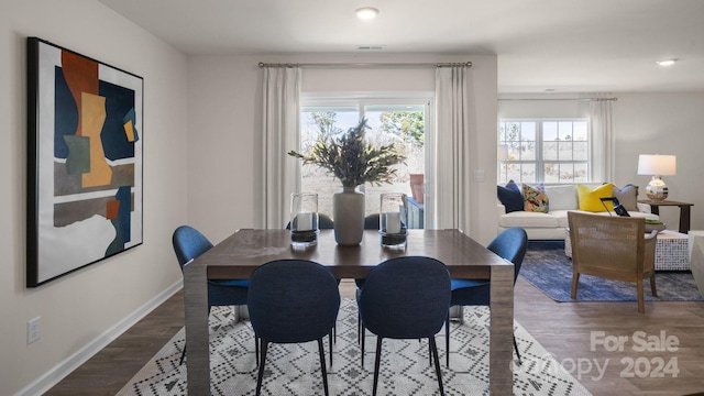 dining space with hardwood / wood-style flooring