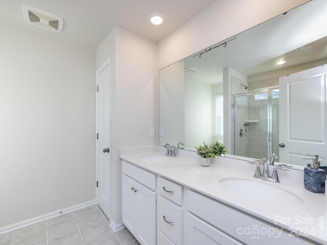 15533 Capps Rd, Charlotte, NC 28278 - bathroom featuring a shower stall, double vanity, recessed lighting, and tile patterned floors