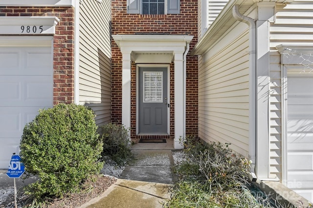 doorway to property featuring a garage