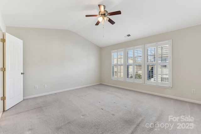 carpeted empty room with vaulted ceiling and ceiling fan