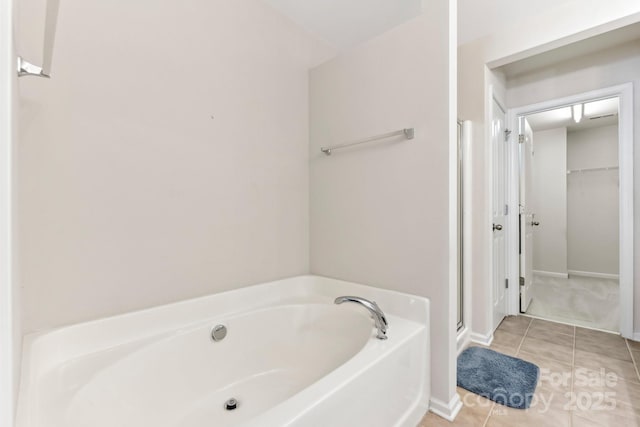 bathroom with a bathtub and tile patterned floors