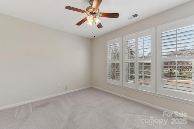 spare room featuring carpet floors and ceiling fan