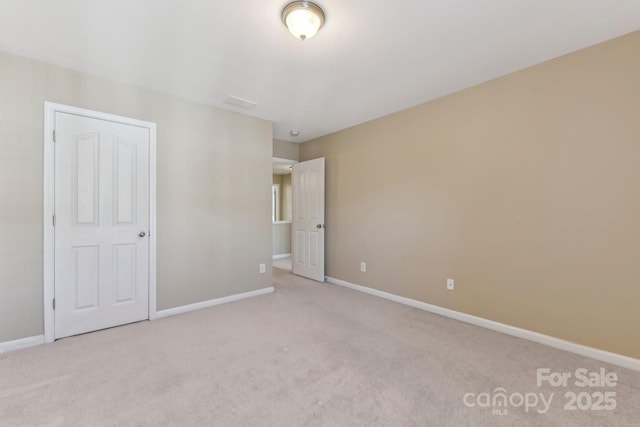 unfurnished bedroom with light colored carpet