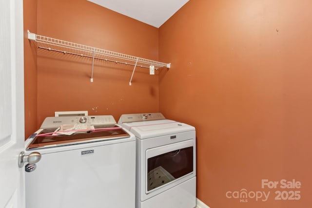 laundry room with washing machine and clothes dryer