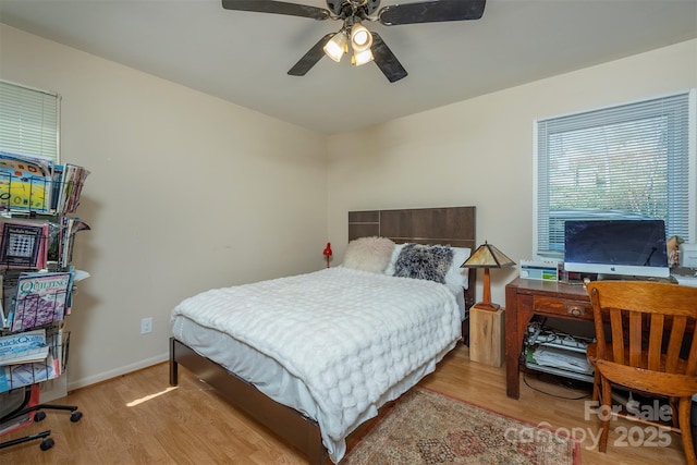 bedroom with ceiling fan and light wood-type flooring