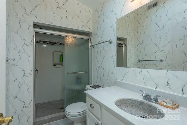 bathroom with toilet, walk in shower, and vanity