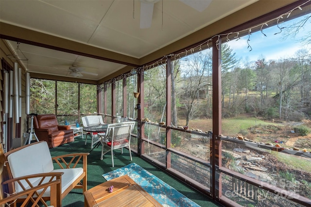 sunroom featuring ceiling fan