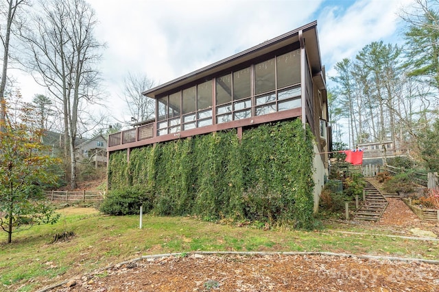 back of property with a sunroom