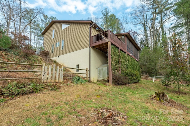 back of house featuring a yard and a wooden deck