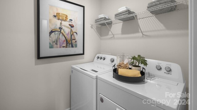 clothes washing area with washing machine and dryer