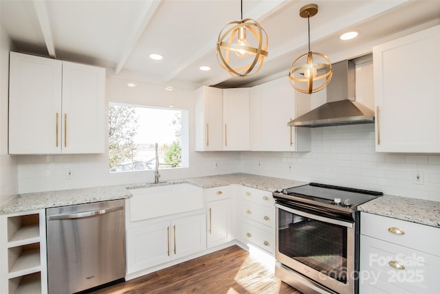 kitchen featuring wall chimney range hood, sink, beamed ceiling, white cabinetry, and stainless steel appliances