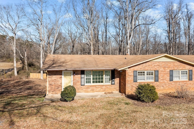 ranch-style home with a front lawn